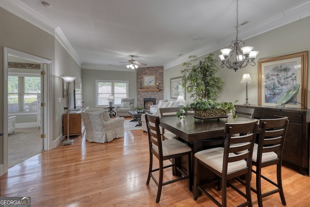 1649-H Lakeview Dr, Young Harris, GA 30582 - dining room featuring ceiling fan, a fireplace, crown molding, light wood-style floors, and a chandelier