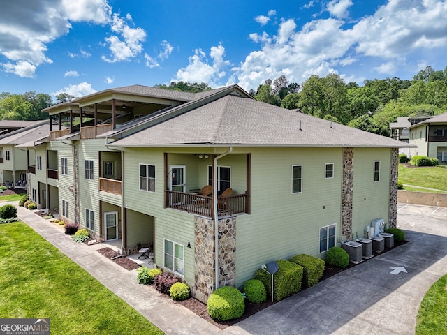 1649-H Lakeview Dr, Young Harris, GA 30582 - view of home's exterior featuring a shingled roof, a yard, a balcony, and stone siding