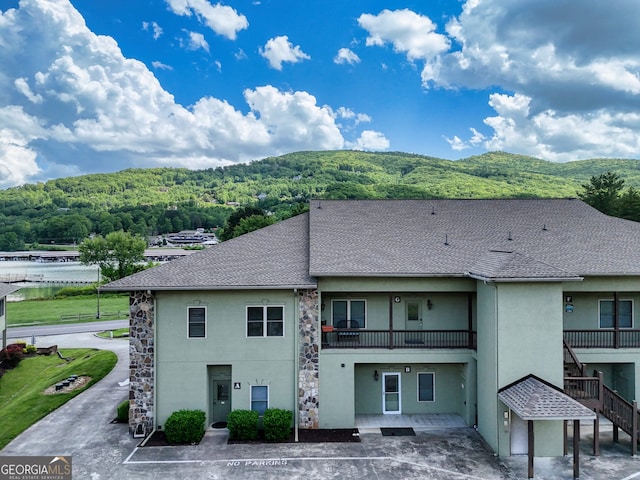 1649-H Lakeview Dr, Young Harris, GA 30582 - rear view of house featuring stucco siding, uncovered parking, a balcony, and a shingled roof
