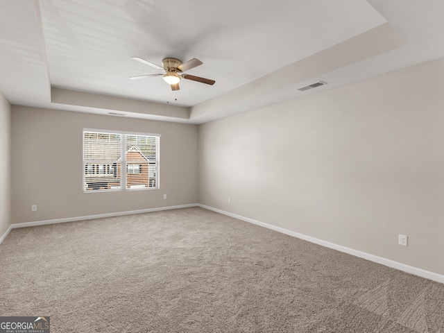 1064 Lear Dr, Locust Grove, GA 30248 - carpeted spare room with a raised ceiling and a ceiling fan