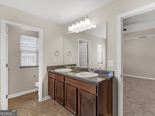1064 Lear Dr, Locust Grove, GA 30248 - bathroom featuring double vanity and baseboards