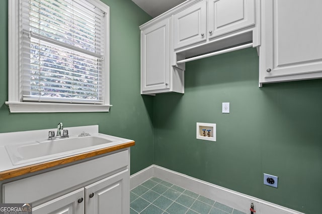 laundry area featuring hookup for a washing machine, baseboards, a sink, cabinet space, and electric dryer hookup