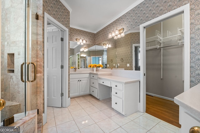 full bathroom featuring ornamental molding, wallpapered walls, vanity, a stall shower, and tile patterned flooring