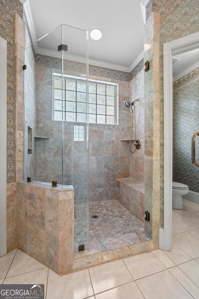 bathroom featuring a stall shower, tile patterned floors, crown molding, and toilet