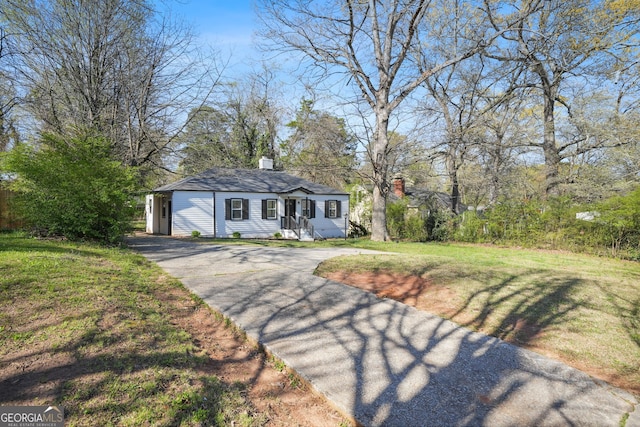 1013 Columbia Dr, Decatur, GA 30030 - view of front of property featuring driveway, a chimney, and a front yard