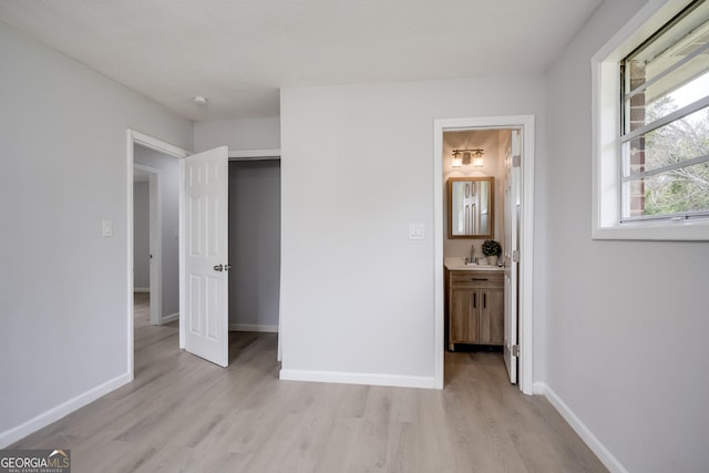 2352 Helsinki Dr, Augusta, GA 30906 - unfurnished bedroom featuring light wood-style flooring, a sink, ensuite bathroom, and baseboards