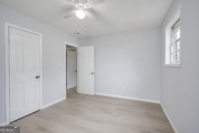 2352 Helsinki Dr, Augusta, GA 30906 - unfurnished bedroom featuring baseboards, light wood-style floors, and a ceiling fan