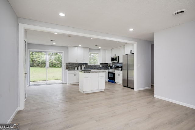 2352 Helsinki Dr, Augusta, GA 30906 - kitchen featuring a sink, tasteful backsplash, appliances with stainless steel finishes, and light wood finished floors