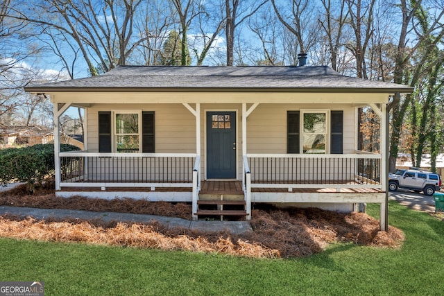 bungalow with covered porch and roof with shingles