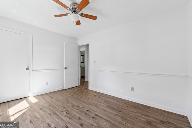 unfurnished bedroom with baseboards, ceiling fan, and wood finished floors