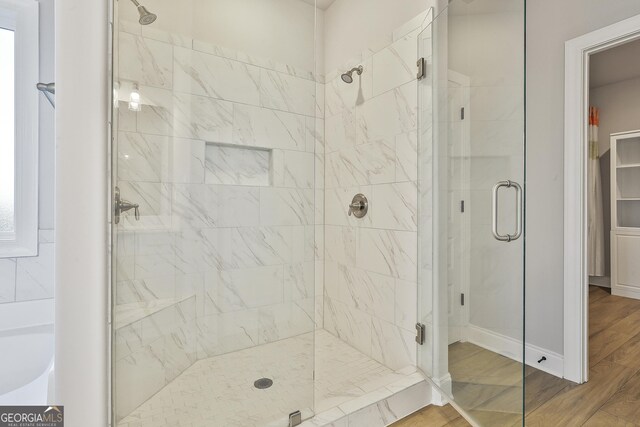 8 Sumner Way, Senoia, GA 30276 - full bath with a garden tub, baseboards, a shower stall, and wood finished floors