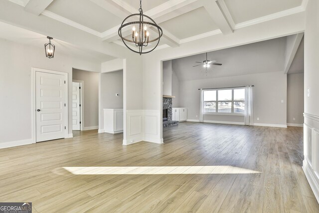 8 Sumner Way, Senoia, GA 30276 - unfurnished living room with light wood-style floors, a fireplace, ceiling fan with notable chandelier, beamed ceiling, and coffered ceiling