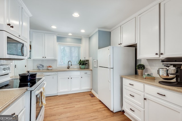 2926 Westbury Dr, Decatur, GA 30033 - kitchen with white cabinetry, a sink, light wood finished floors, and white appliances