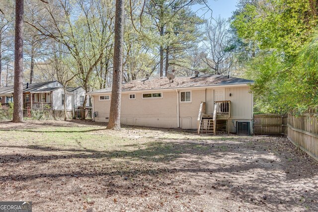 2926 Westbury Dr, Decatur, GA 30033 - back of property with crawl space, central AC unit, and fence