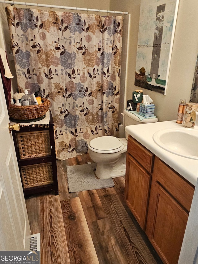315 Saratoga Pl, Riverdale, GA 30296 - bathroom featuring toilet, visible vents, wood finished floors, a shower with shower curtain, and vanity