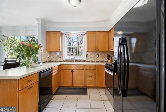 1472 Hartman Dr SW, Lilburn, GA 30047 - kitchen with black appliances, light countertops, a sink, a peninsula, and decorative backsplash