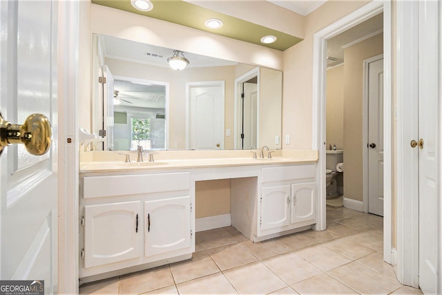 1472 Hartman Dr SW, Lilburn, GA 30047 - bathroom with double vanity, tile patterned floors, crown molding, ceiling fan, and toilet