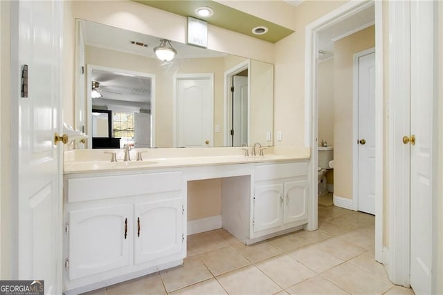 1472 Hartman Dr SW, Lilburn, GA 30047 - full bathroom with double vanity, tile patterned flooring, toilet, and baseboards