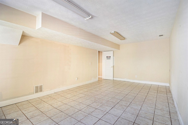 1472 Hartman Dr SW, Lilburn, GA 30047 - spare room featuring a textured ceiling, light tile patterned floors, and baseboards