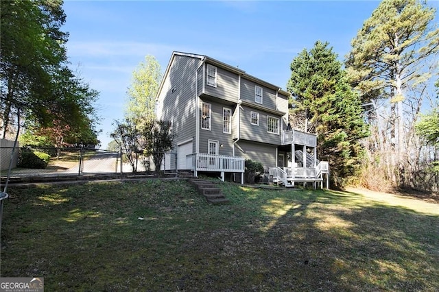1472 Hartman Dr SW, Lilburn, GA 30047 - rear view of house with an attached garage and a deck