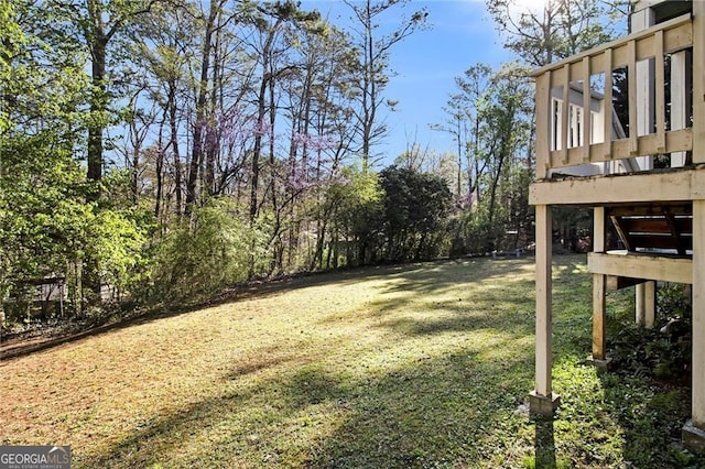 1472 Hartman Dr SW, Lilburn, GA 30047 - view of grassy yard featuring a deck