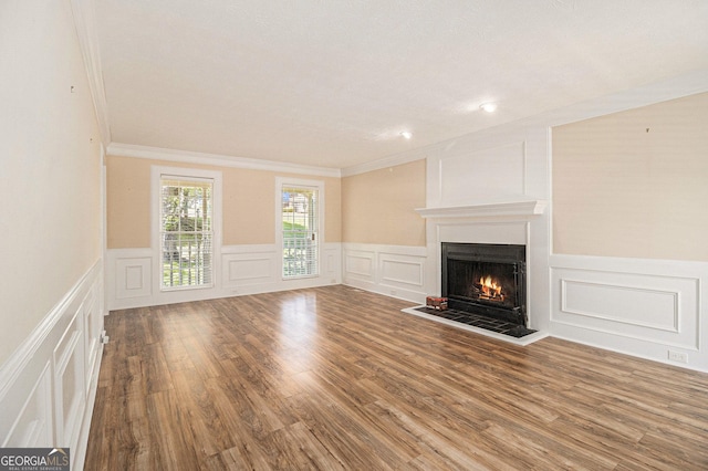 1472 Hartman Dr SW, Lilburn, GA 30047 - unfurnished living room featuring a decorative wall, a lit fireplace, ornamental molding, a wainscoted wall, and wood finished floors