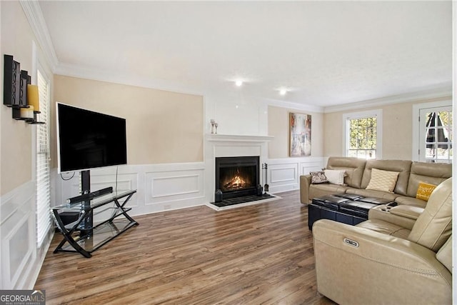1472 Hartman Dr SW, Lilburn, GA 30047 - living room featuring a decorative wall, a lit fireplace, ornamental molding, wood finished floors, and wainscoting