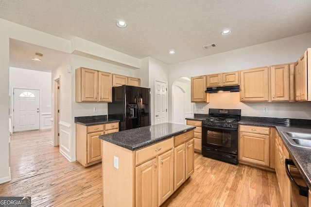 4157 Medlock Woods Dr, Snellville, GA 30039 - kitchen featuring under cabinet range hood, light brown cabinets, visible vents, black appliances, and arched walkways