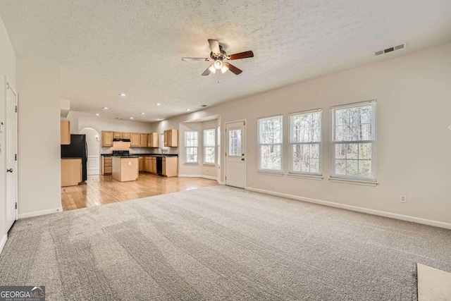 4157 Medlock Woods Dr, Snellville, GA 30039 - unfurnished living room featuring ceiling fan, baseboards, light colored carpet, and visible vents