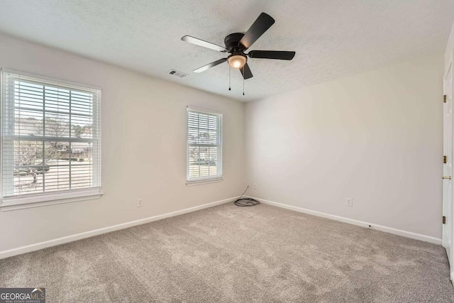 4157 Medlock Woods Dr, Snellville, GA 30039 - empty room featuring a textured ceiling, visible vents, carpet, baseboards, and a ceiling fan