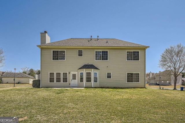 4157 Medlock Woods Dr, Snellville, GA 30039 - rear view of house featuring a lawn and a chimney