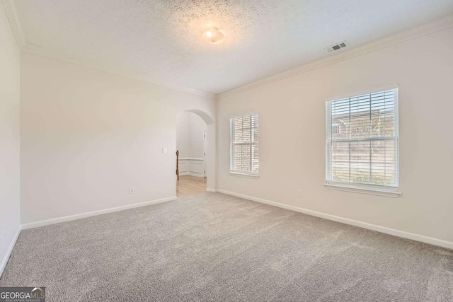 4157 Medlock Woods Dr, Snellville, GA 30039 - carpeted spare room with visible vents, crown molding, arched walkways, and a textured ceiling