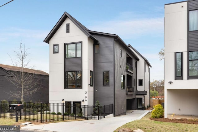 exterior space with stucco siding and fence