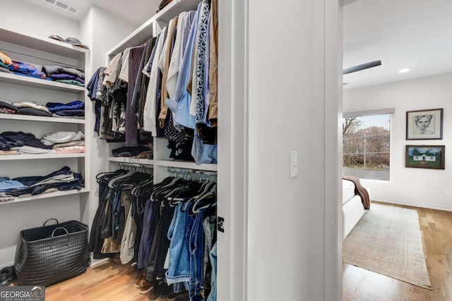 walk in closet with visible vents and wood finished floors