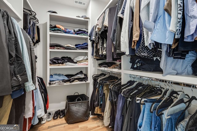 spacious closet with visible vents and wood finished floors