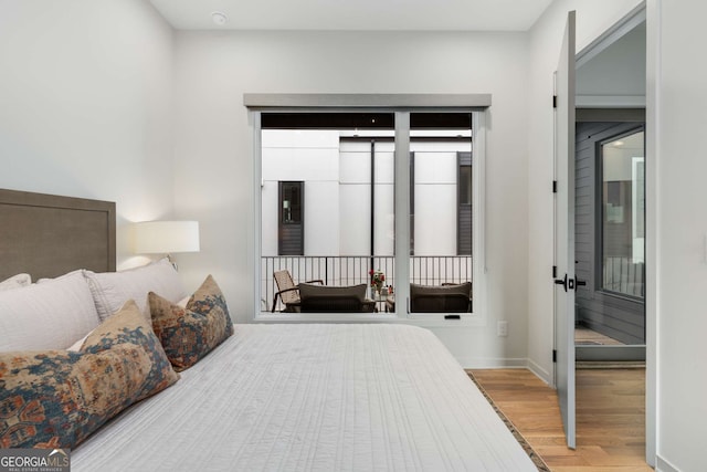 bedroom with baseboards and wood finished floors