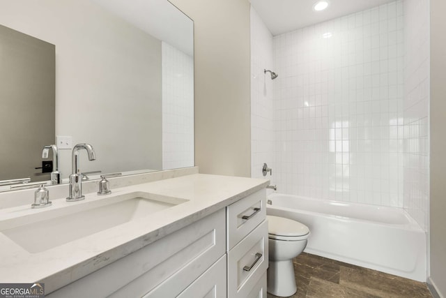 bathroom with toilet, shower / bathing tub combination, and vanity