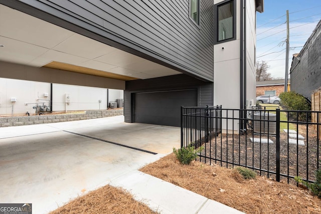 exterior space featuring fence and concrete driveway
