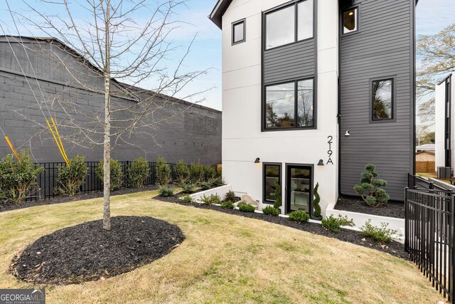 exterior space with fence and a lawn