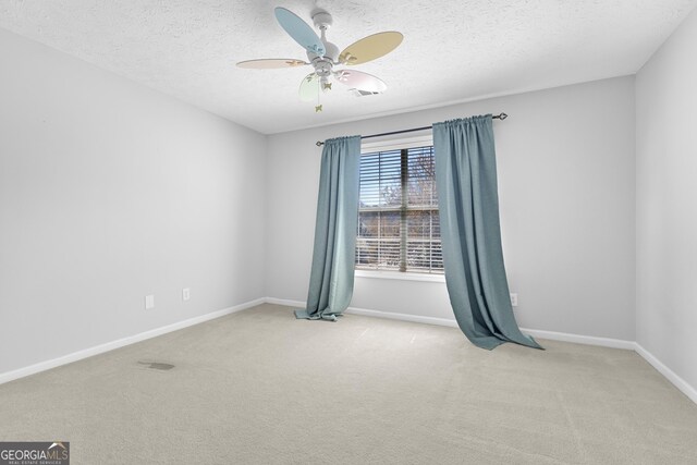 1484 Highland Bluff Ct, Suwanee, GA 30024 - spare room featuring baseboards, a textured ceiling, carpet floors, and a ceiling fan