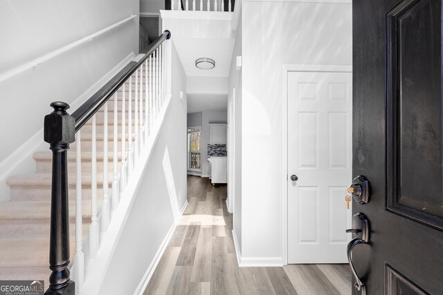 1484 Highland Bluff Ct, Suwanee, GA 30024 - entryway with baseboards, light wood-style floors, and stairs