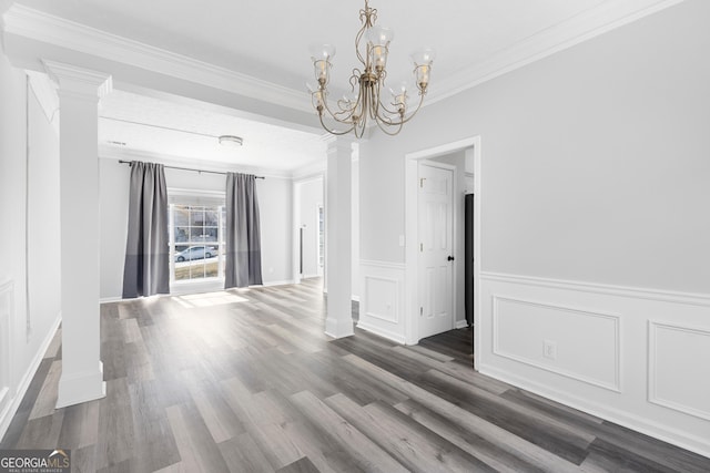 1484 Highland Bluff Ct, Suwanee, GA 30024 - unfurnished dining area with a decorative wall, ornamental molding, wood finished floors, decorative columns, and a notable chandelier