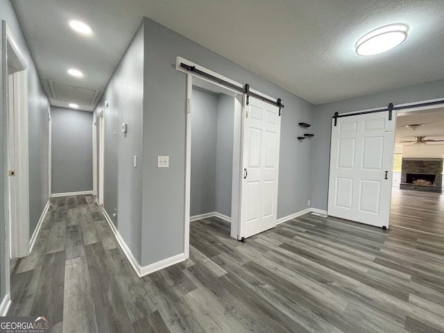 1105 Claxton Dairy Rd, Dublin, GA 31021 - corridor with a barn door, wood finished floors, attic access, baseboards, and recessed lighting