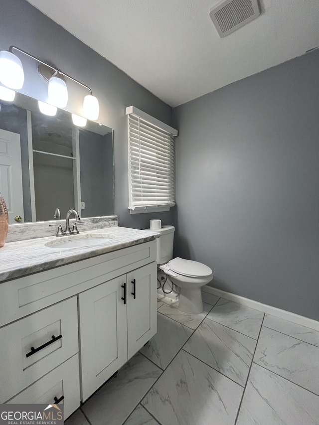 1105 Claxton Dairy Rd, Dublin, GA 31021 - full bath featuring marble finish floors, vanity, an enclosed shower, toilet, and baseboards