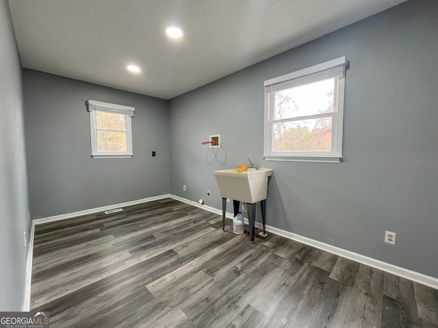 1105 Claxton Dairy Rd, Dublin, GA 31021 - laundry room featuring hookup for a washing machine, wood finished floors, recessed lighting, baseboards, and a textured ceiling