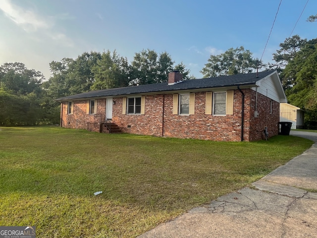 1105 Claxton Dairy Rd, Dublin, GA 31021 - ranch-style house with a chimney, brick siding, a front yard, and driveway