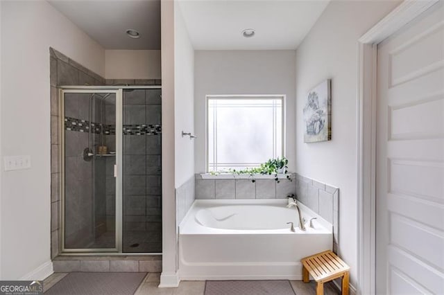 197 Saddleridge Dr, Bremen, GA 30110 - bathroom featuring tile patterned floors, a garden tub, and a stall shower