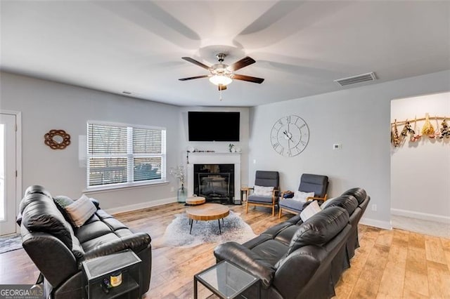 197 Saddleridge Dr, Bremen, GA 30110 - living room featuring ceiling fan, light wood finished floors, and a glass covered fireplace