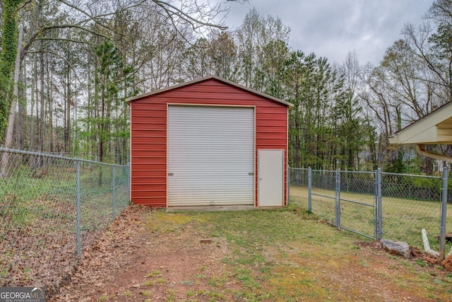 view of outbuilding featuring a gate, an outdoor structure, and fence