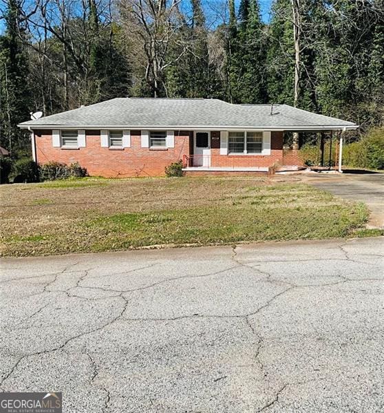 1979 SE Bencal Dr SE Unit 1979, Atlanta, GA 30316 - ranch-style home featuring driveway, a front yard, brick siding, a carport, and a wooded view